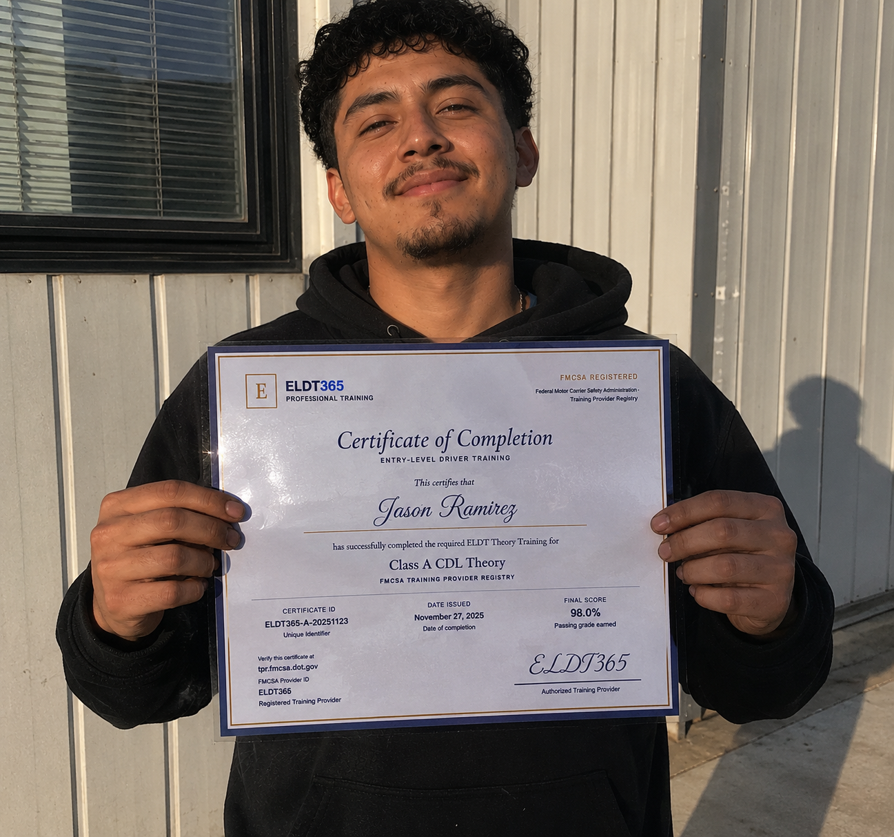 Jason R. holding his ELDT365 Class A CDL certificate